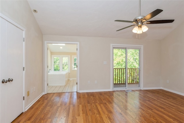 unfurnished room featuring light wood-type flooring, ceiling fan, and a healthy amount of sunlight