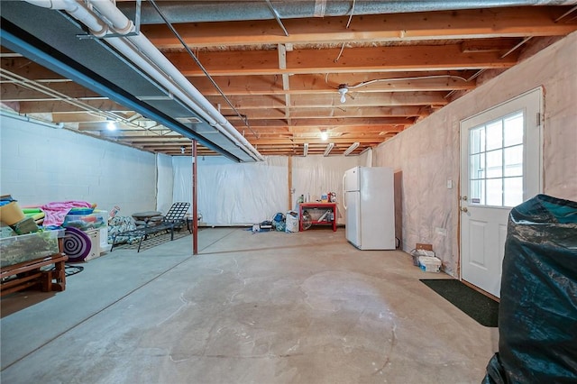 basement with white fridge