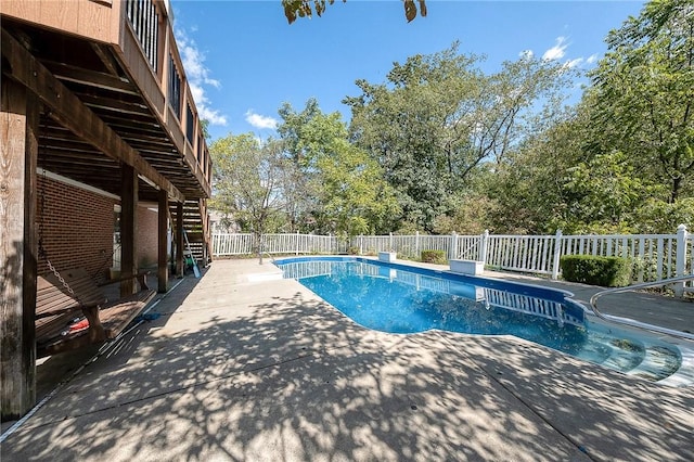 view of pool featuring a diving board and a patio