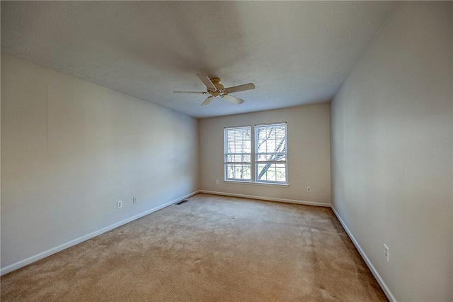 carpeted spare room featuring a textured ceiling and ceiling fan