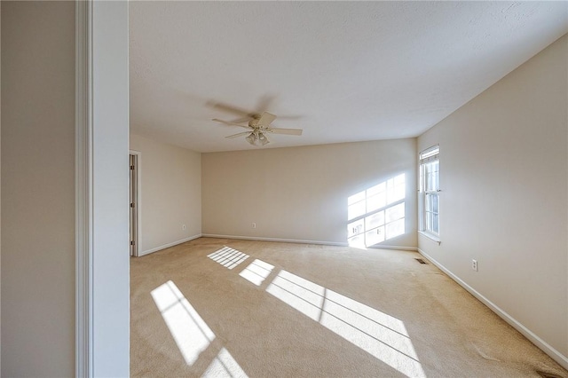 carpeted empty room featuring ceiling fan