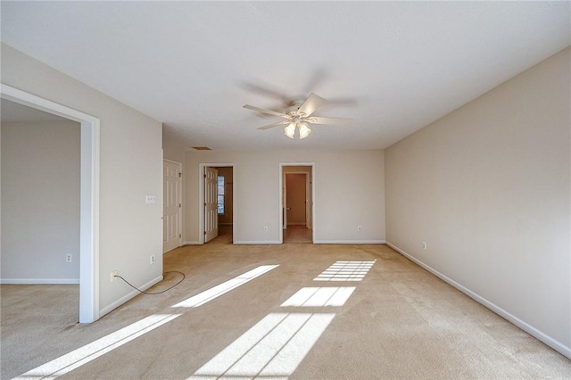 carpeted spare room with ceiling fan