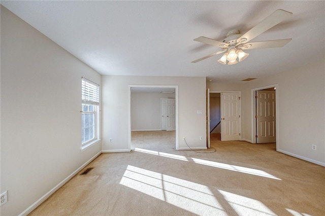 unfurnished bedroom with ceiling fan and light colored carpet