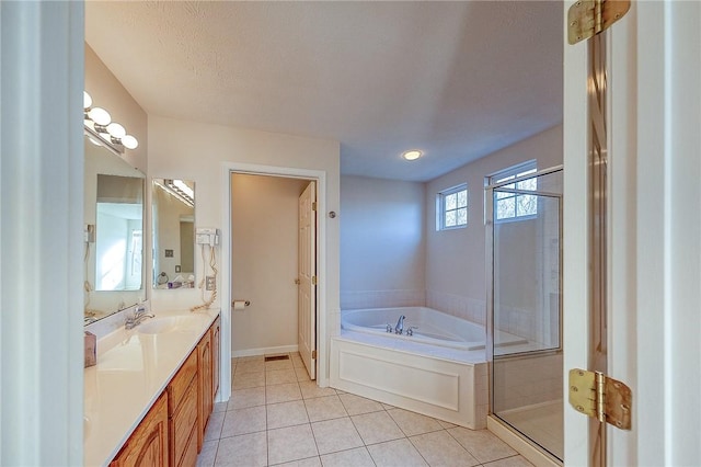 bathroom with tile patterned floors, vanity, a textured ceiling, and shower with separate bathtub