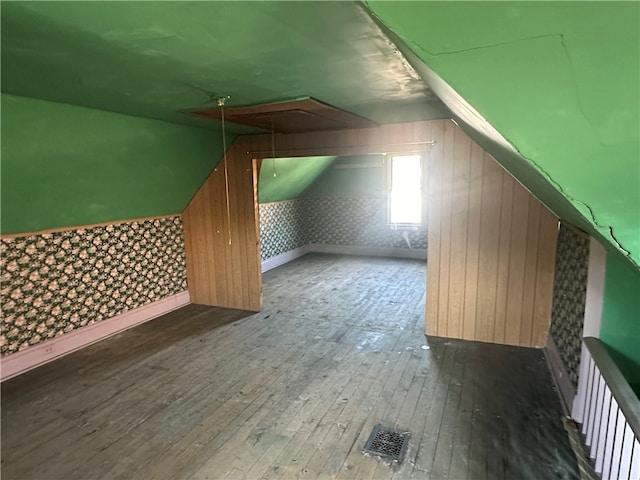 bonus room featuring lofted ceiling and dark hardwood / wood-style floors