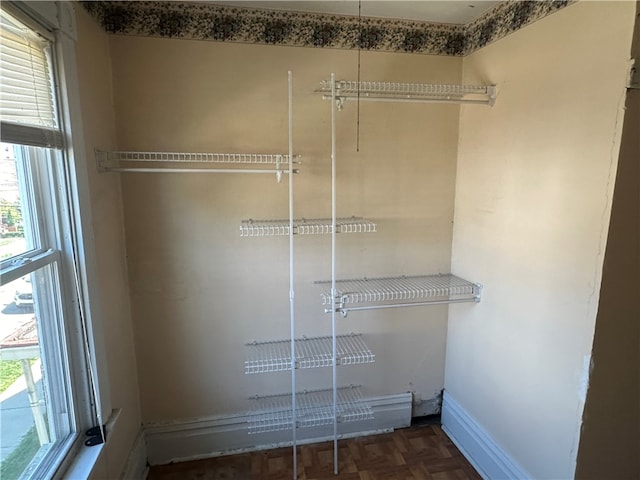 spacious closet with parquet floors