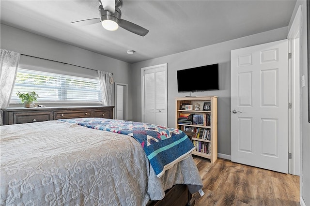 bedroom with ceiling fan and dark hardwood / wood-style floors