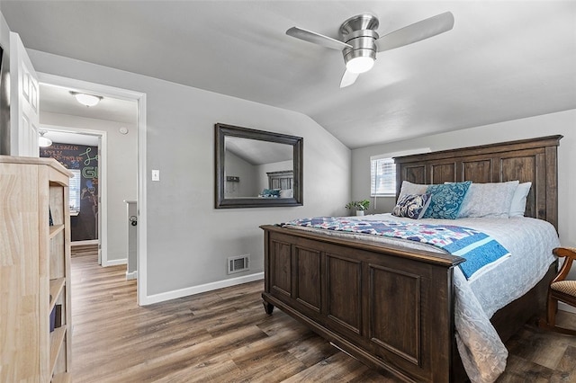 bedroom with dark wood-type flooring, ceiling fan, and vaulted ceiling