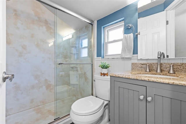 bathroom with vanity, toilet, and an enclosed shower