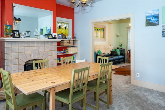 carpeted dining room with a notable chandelier