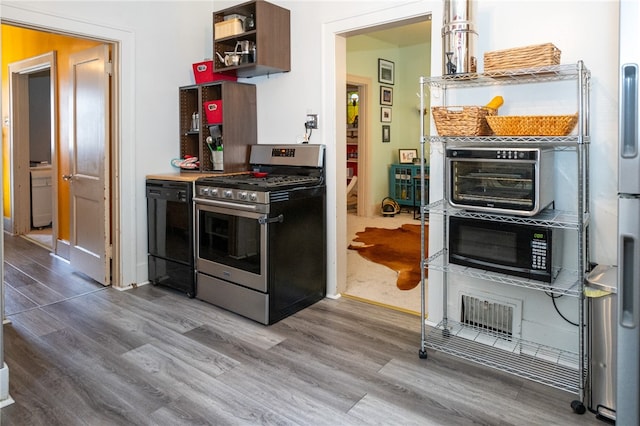 kitchen featuring black appliances and wood-type flooring