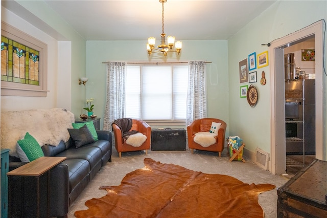 living room featuring a chandelier and carpet floors