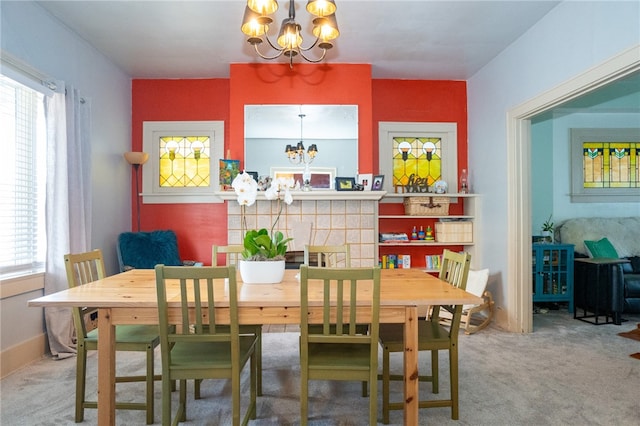 carpeted dining area featuring a notable chandelier and a healthy amount of sunlight