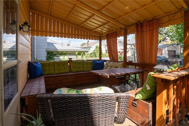 sunroom featuring wood ceiling, vaulted ceiling, and a healthy amount of sunlight