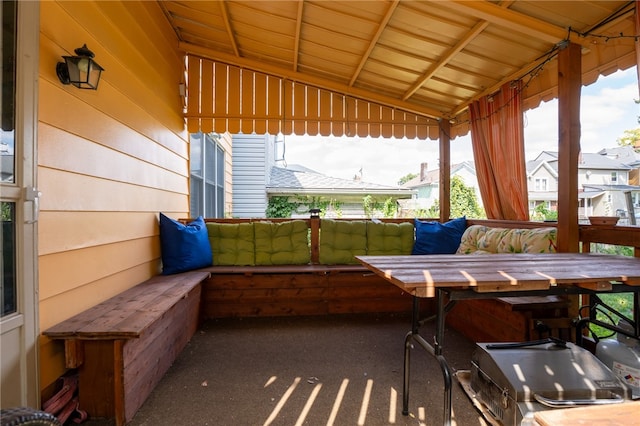 sunroom / solarium featuring vaulted ceiling and wooden ceiling