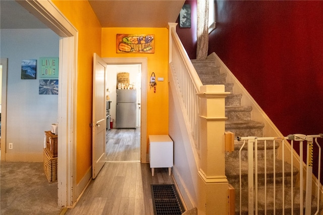 stairway featuring hardwood / wood-style floors