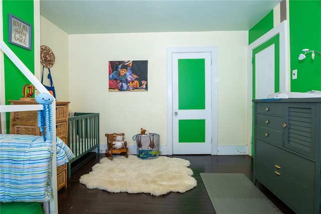 bedroom with dark wood-type flooring