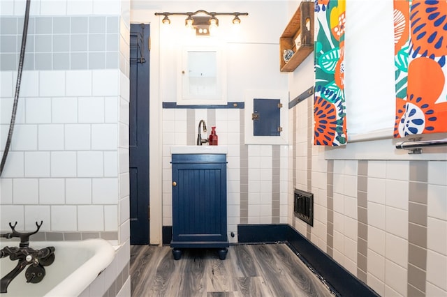 bathroom with hardwood / wood-style floors, sink, and  shower combination