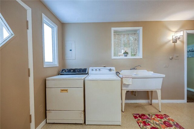 washroom featuring independent washer and dryer, sink, and electric panel