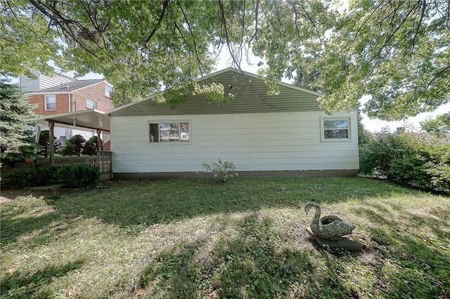 view of side of home featuring a yard