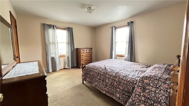 carpeted bedroom with multiple windows