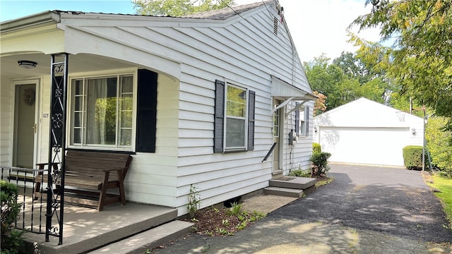 view of property exterior featuring a garage and an outdoor structure