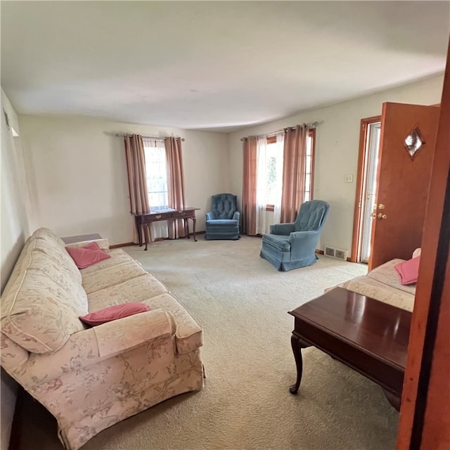 living room featuring carpet floors and a healthy amount of sunlight