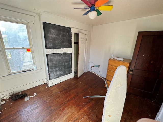 interior space with ceiling fan, plenty of natural light, and dark hardwood / wood-style flooring