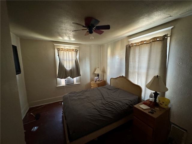 bedroom featuring a textured ceiling and ceiling fan