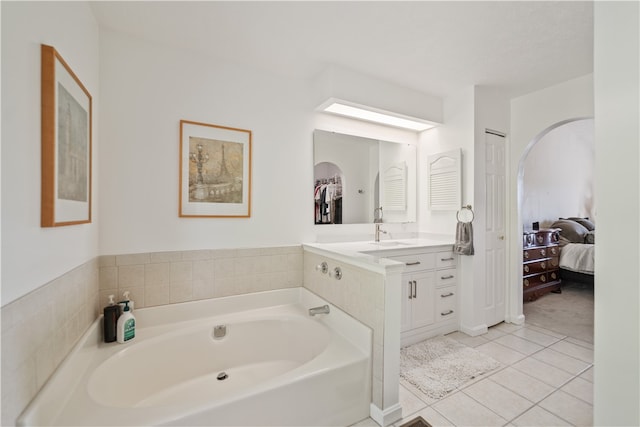 bathroom featuring vanity, a bathtub, and tile patterned floors