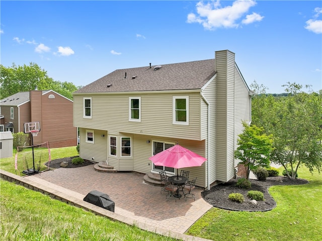 rear view of property featuring a yard and a patio