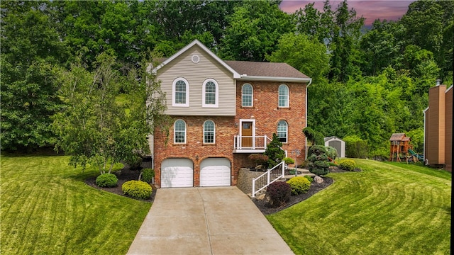 view of front of house featuring a yard, a storage shed, a playground, and a garage