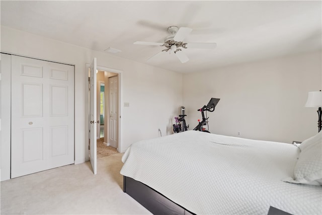 carpeted bedroom with a closet and ceiling fan