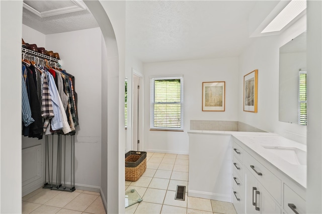 bathroom with vanity, a textured ceiling, and tile patterned flooring