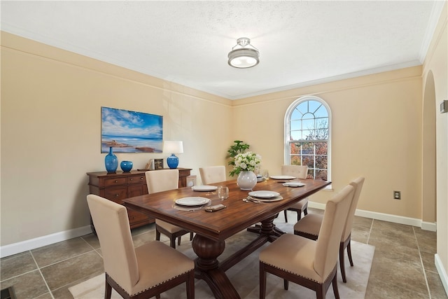 dining room with ornamental molding and a textured ceiling