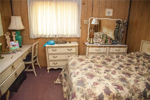 carpeted bedroom featuring wooden walls