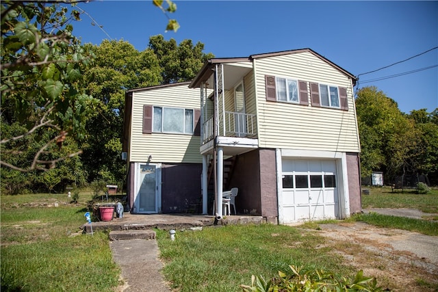 view of front of property with a garage, a balcony, and a front yard