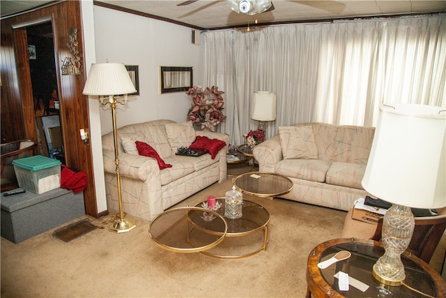 carpeted living room with ornamental molding and ceiling fan