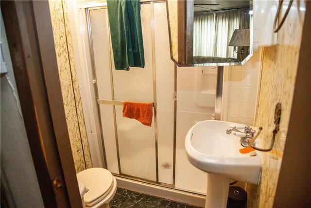 bathroom with toilet and a shower with shower door