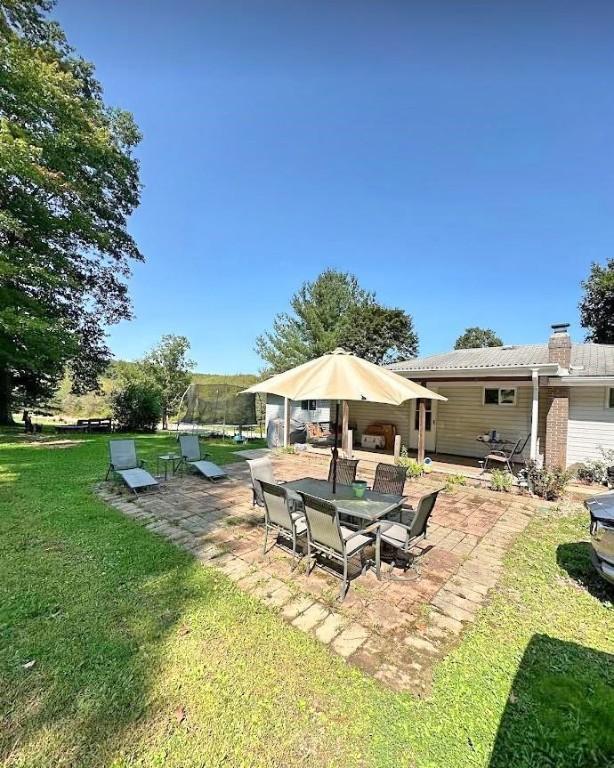 view of yard with a patio area and a trampoline