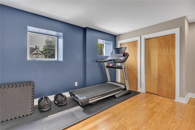 exercise room with light hardwood / wood-style floors