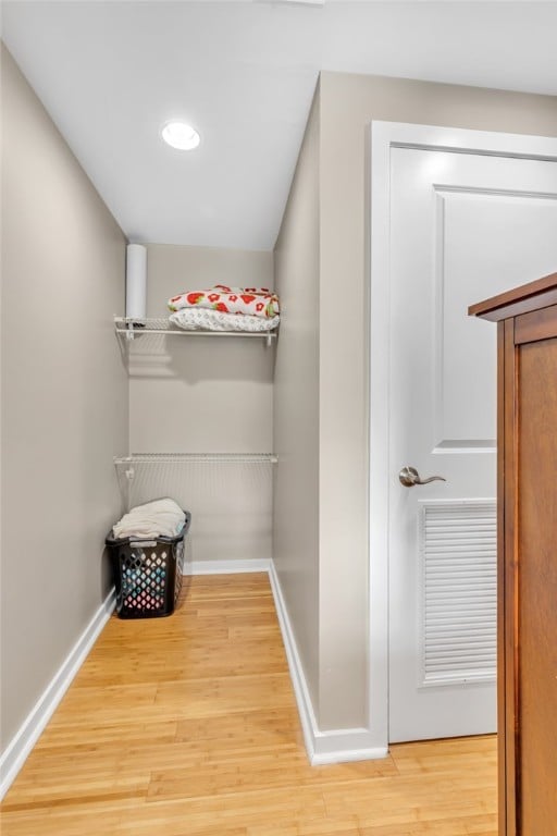 spacious closet with light hardwood / wood-style flooring