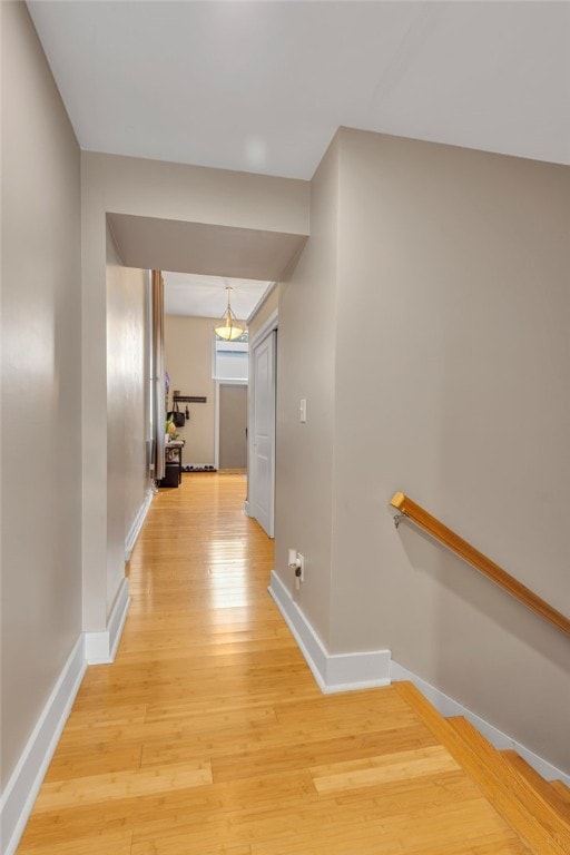 corridor with light wood-type flooring