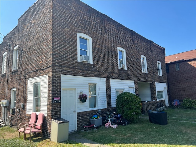 back of house featuring a yard and cooling unit