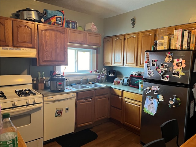 kitchen featuring sink, white appliances, and dark hardwood / wood-style flooring