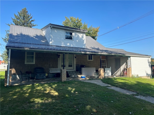 rear view of property with a lawn