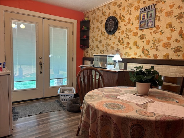 dining room with french doors, a textured ceiling, and dark wood-type flooring