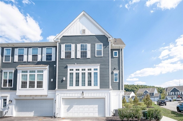 multi unit property featuring a garage and central air condition unit