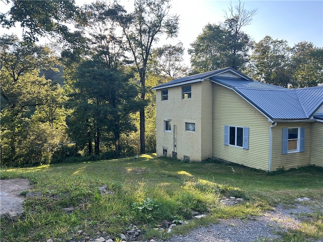 view of property exterior with a lawn