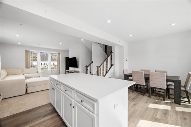 kitchen featuring white cabinetry, a kitchen island, and light hardwood / wood-style floors